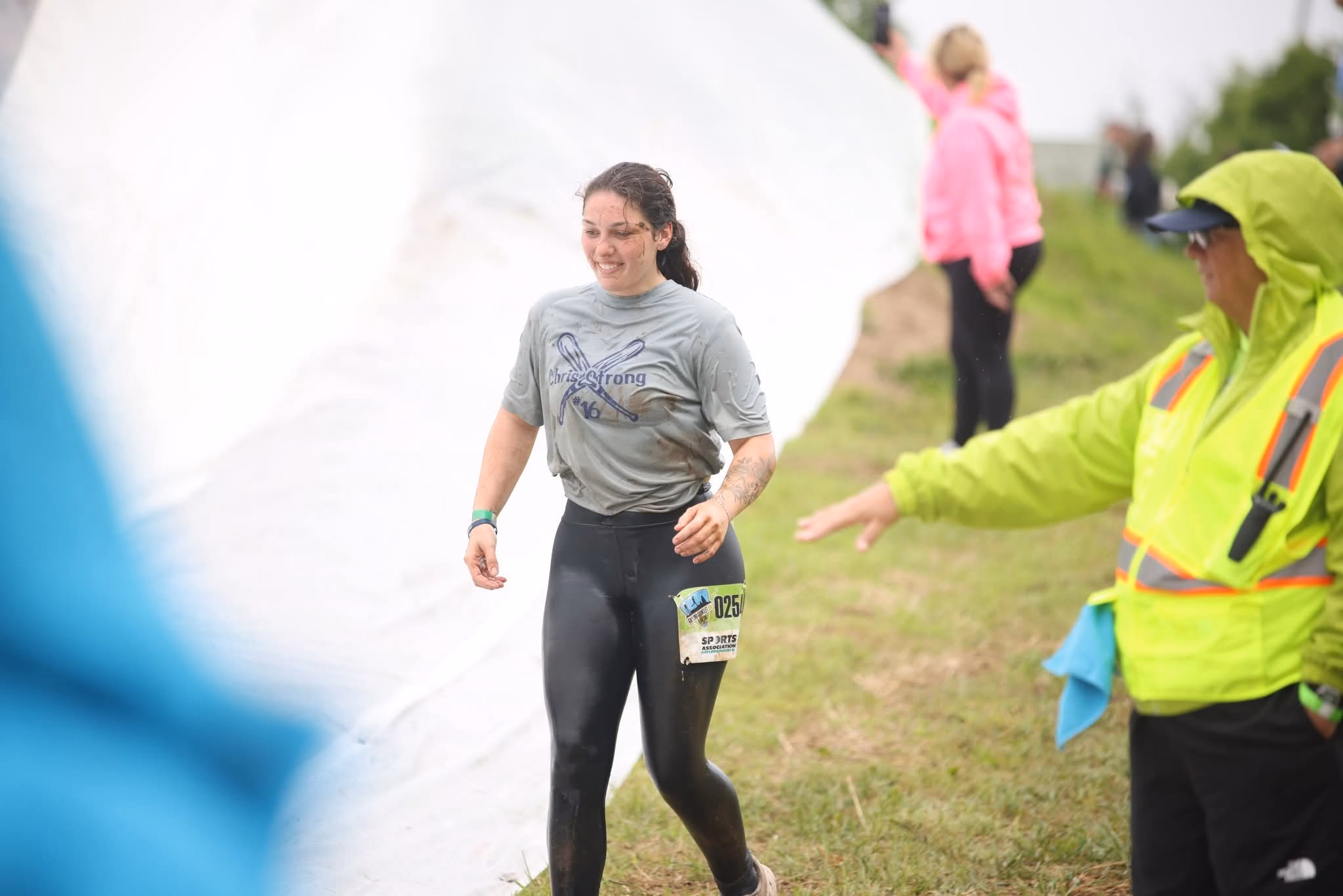A CERT volunteer cheers a runner on along the course