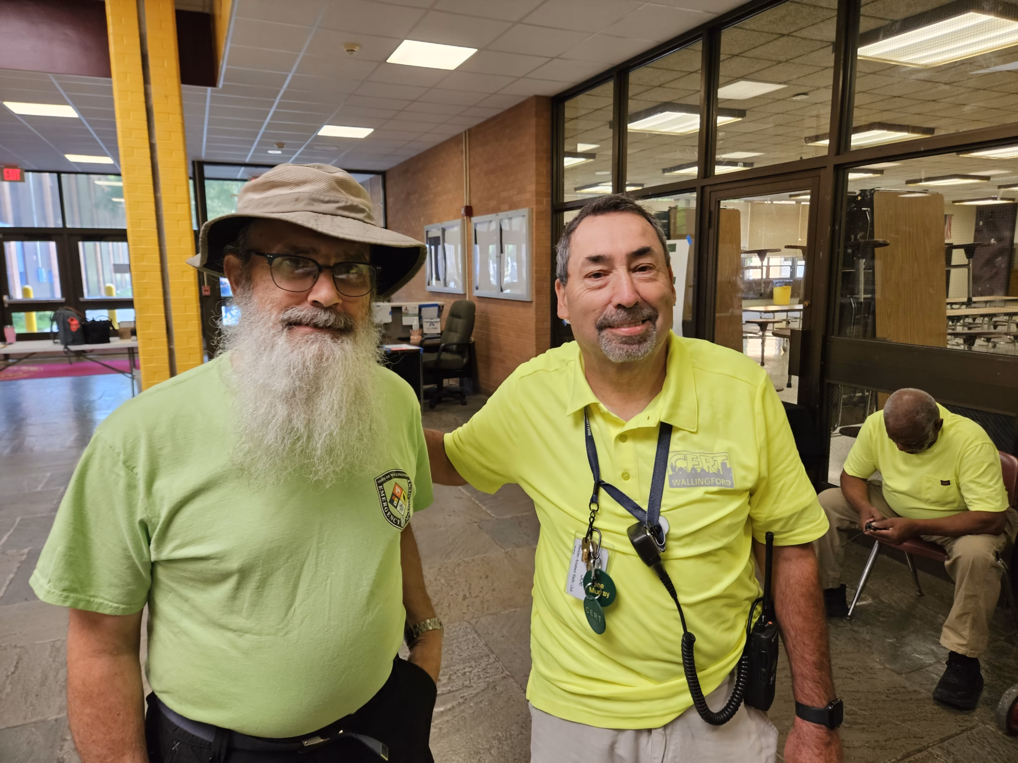 Two smiling CERT volunteers in green shirts at the BioPOD exercise