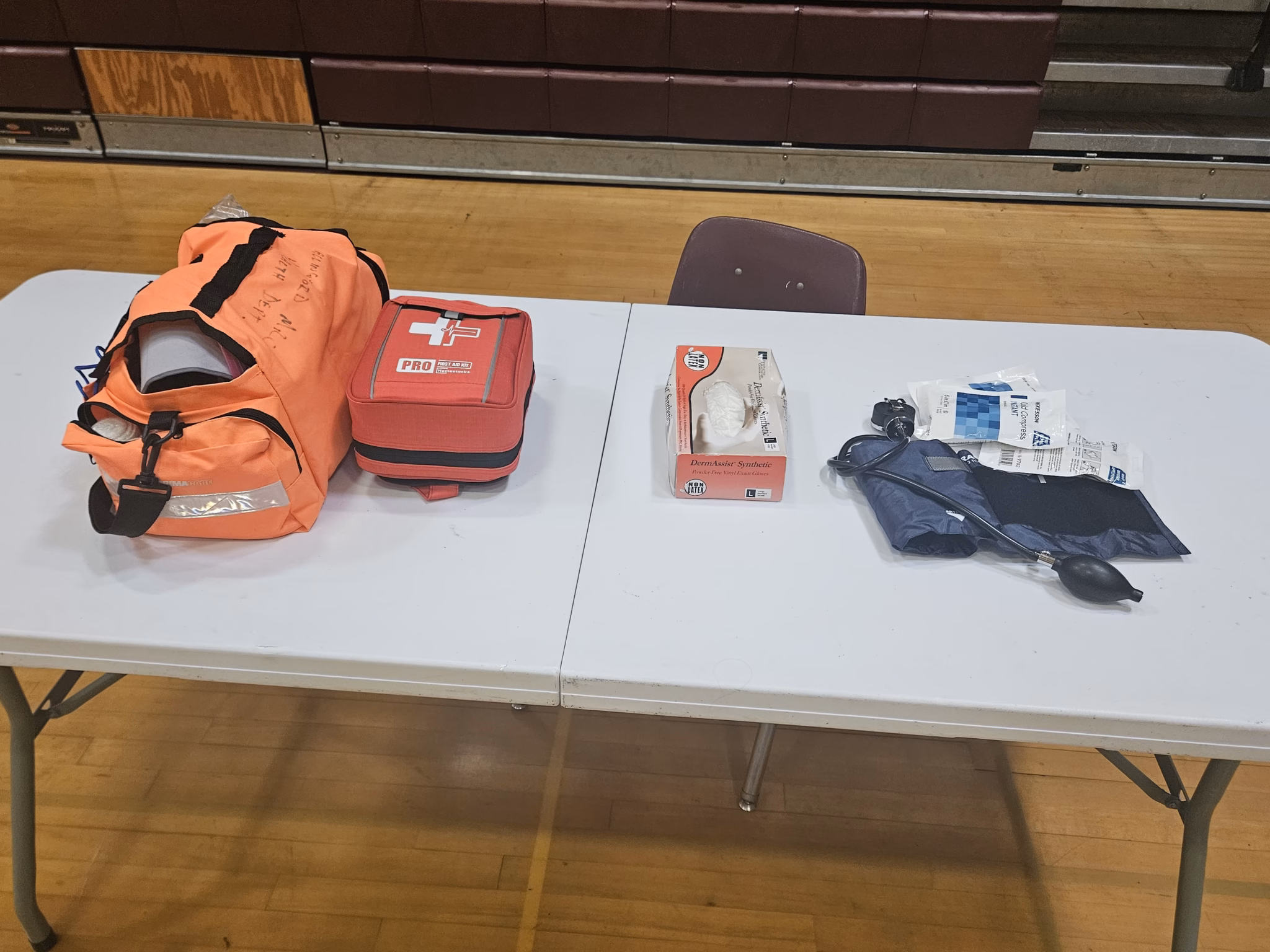 First aid bags and a blood pressure cuff laid out on a table