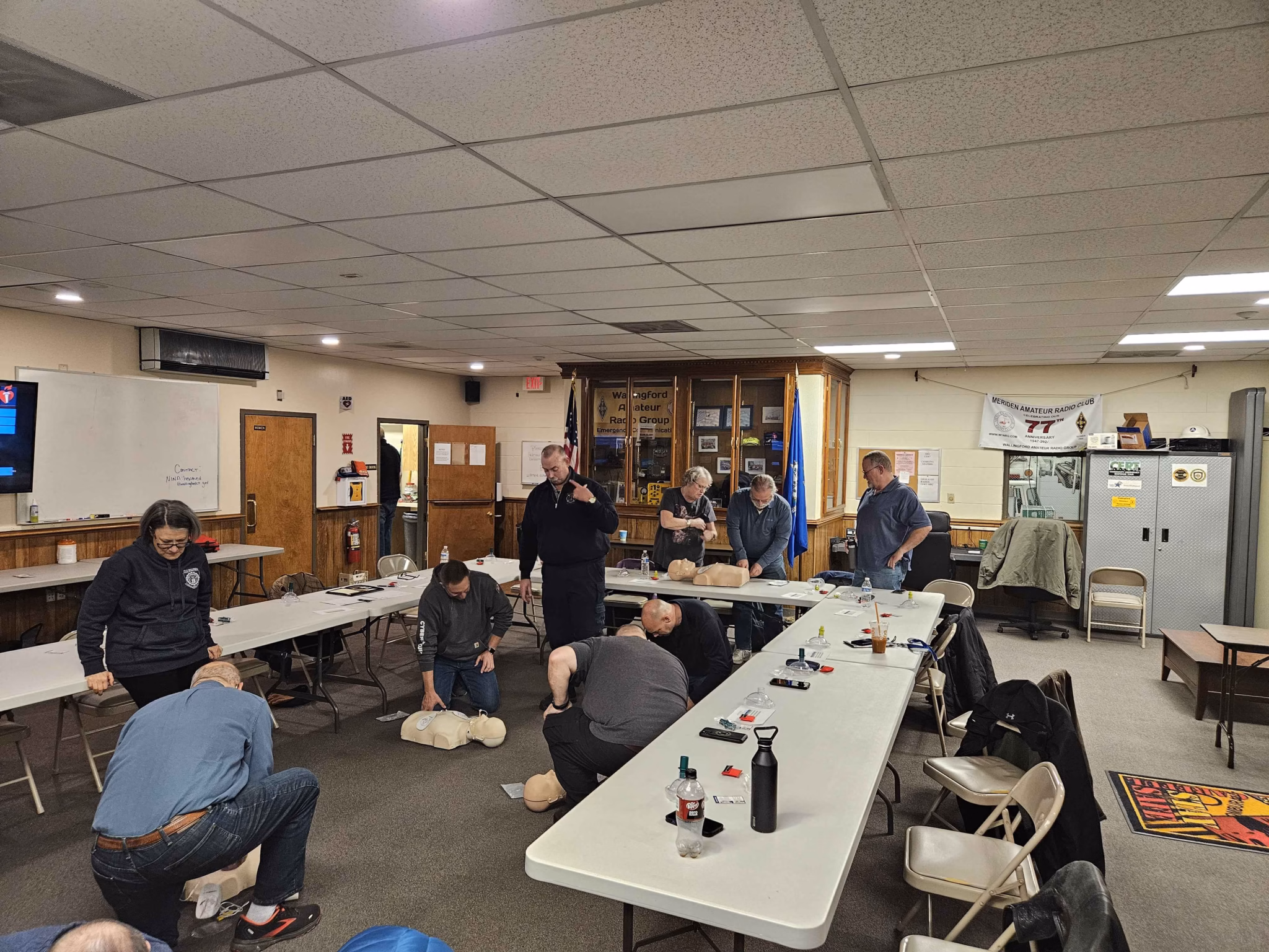 Students kneel to practise CPR during class