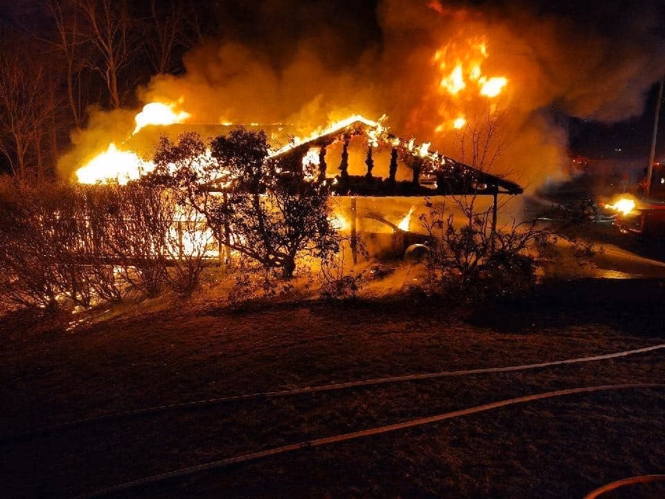 A house fire burning at night